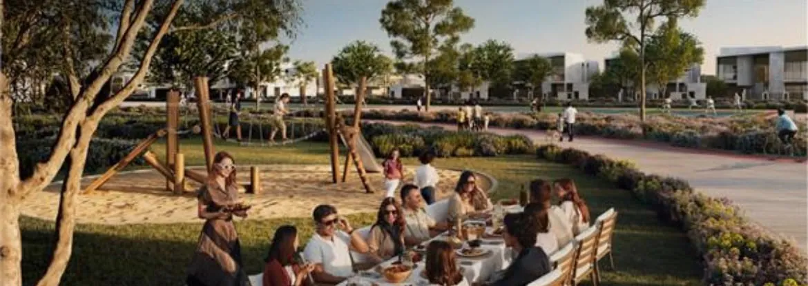 Neighbours gathered at a table in a community park